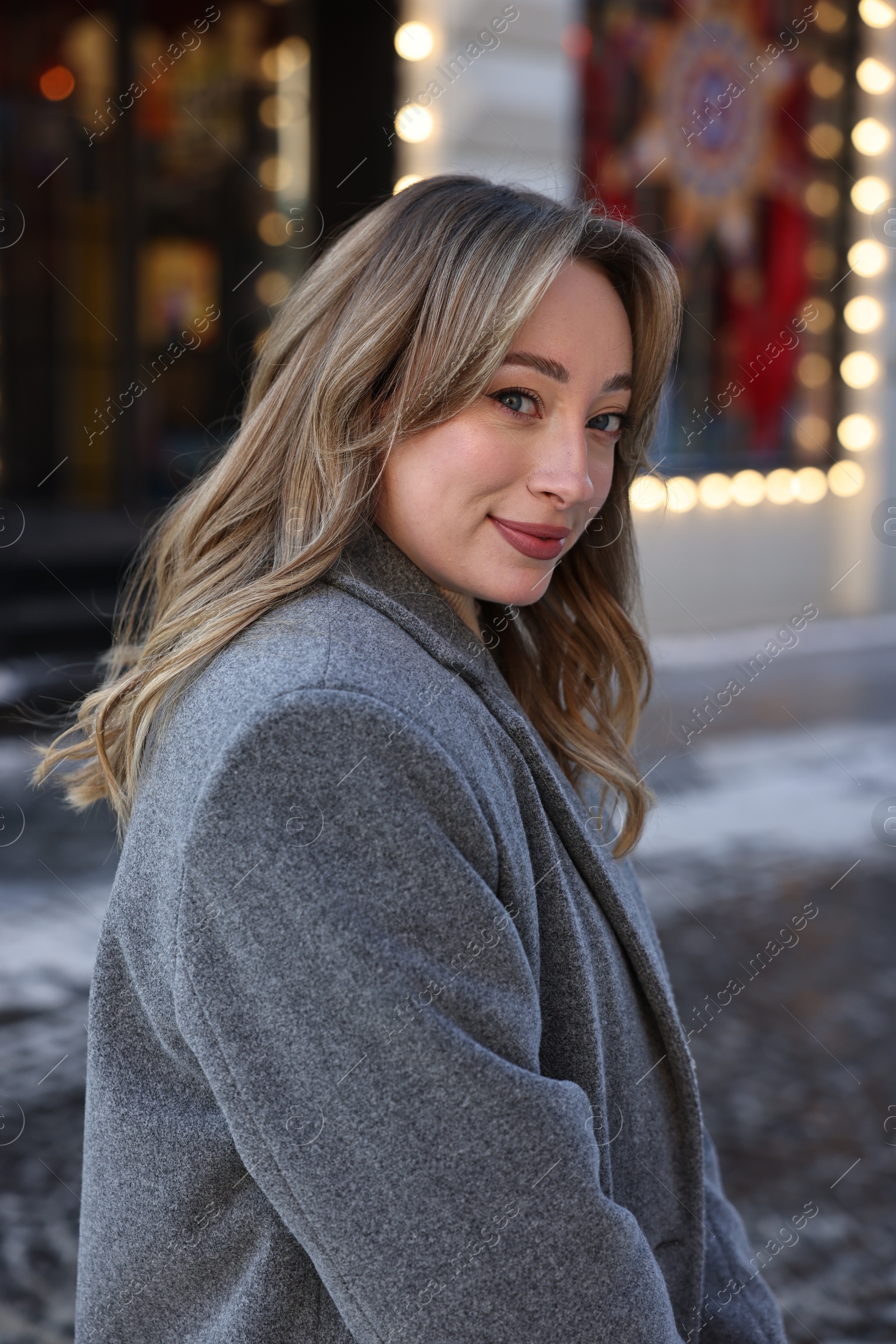 Photo of Portrait of charming woman on city street in winter