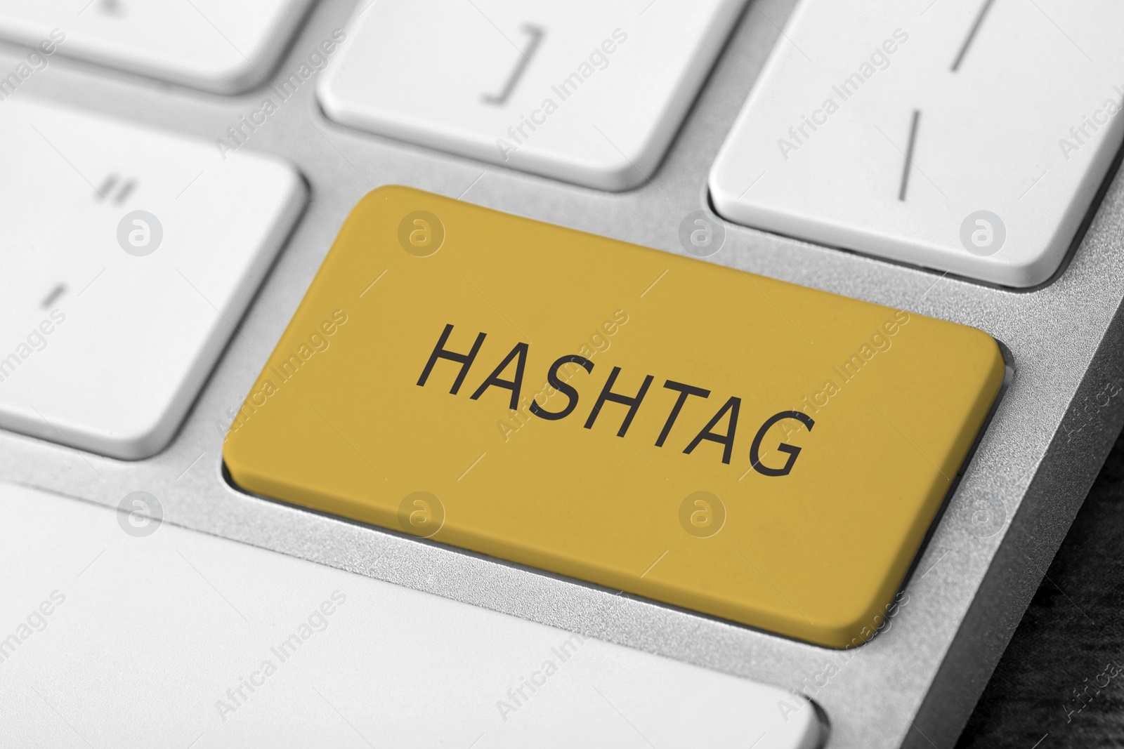 Image of Yellow button with word HASHTAG on computer keyboard, closeup