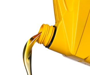 Photo of Pouring motor oil from yellow container on white background, closeup