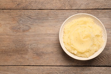 Photo of Body scrub in bowl on wooden table, top view. Space for text