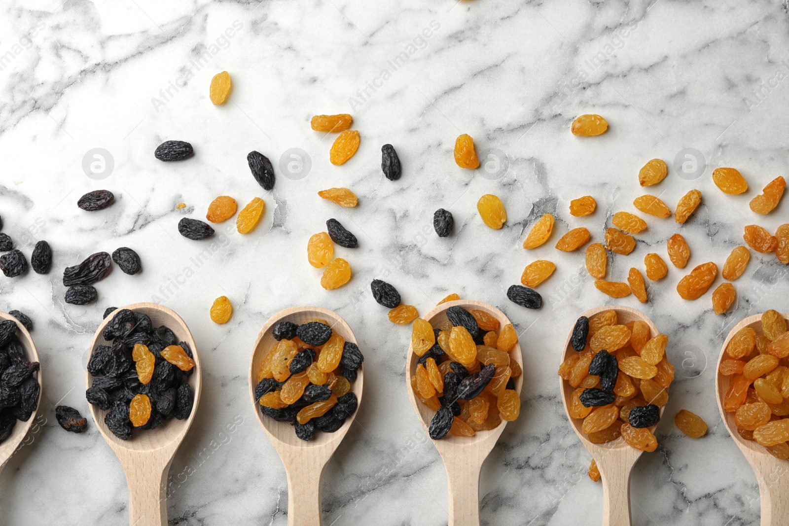 Photo of Flat lay composition with raisins on marble background. Dried fruit as healthy snack