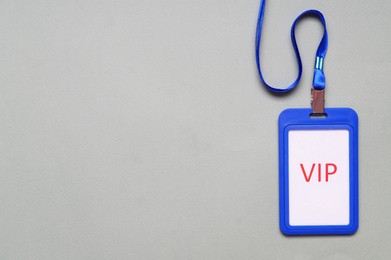 Photo of Plastic vip badge on light gray background, top view. Space for text