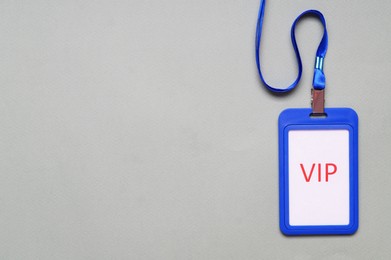 Plastic vip badge on light gray background, top view. Space for text