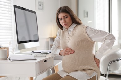 Tired pregnant woman working at home. Maternity leave