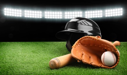 Image of Baseball bat, glove, helmet and ball on grass at stadium. Banner design with space for text