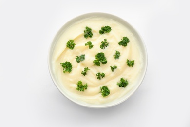 Photo of Bowl with tasty mashed potatoes on white background, top view