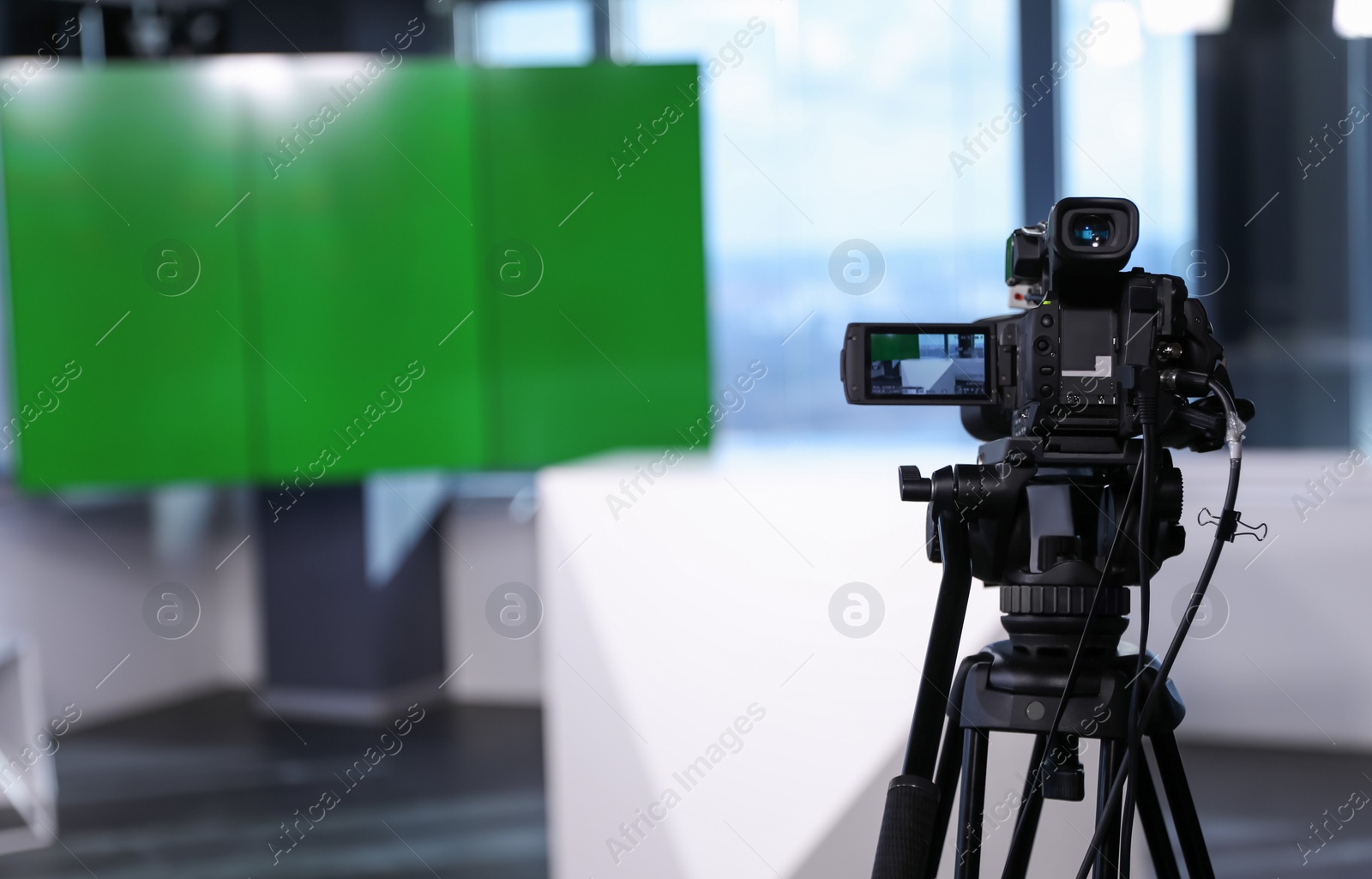 Photo of Modern video recording studio with professional equipment, focus on camera