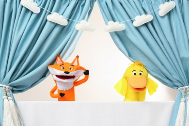 Photo of Creative puppet show on white stage indoors