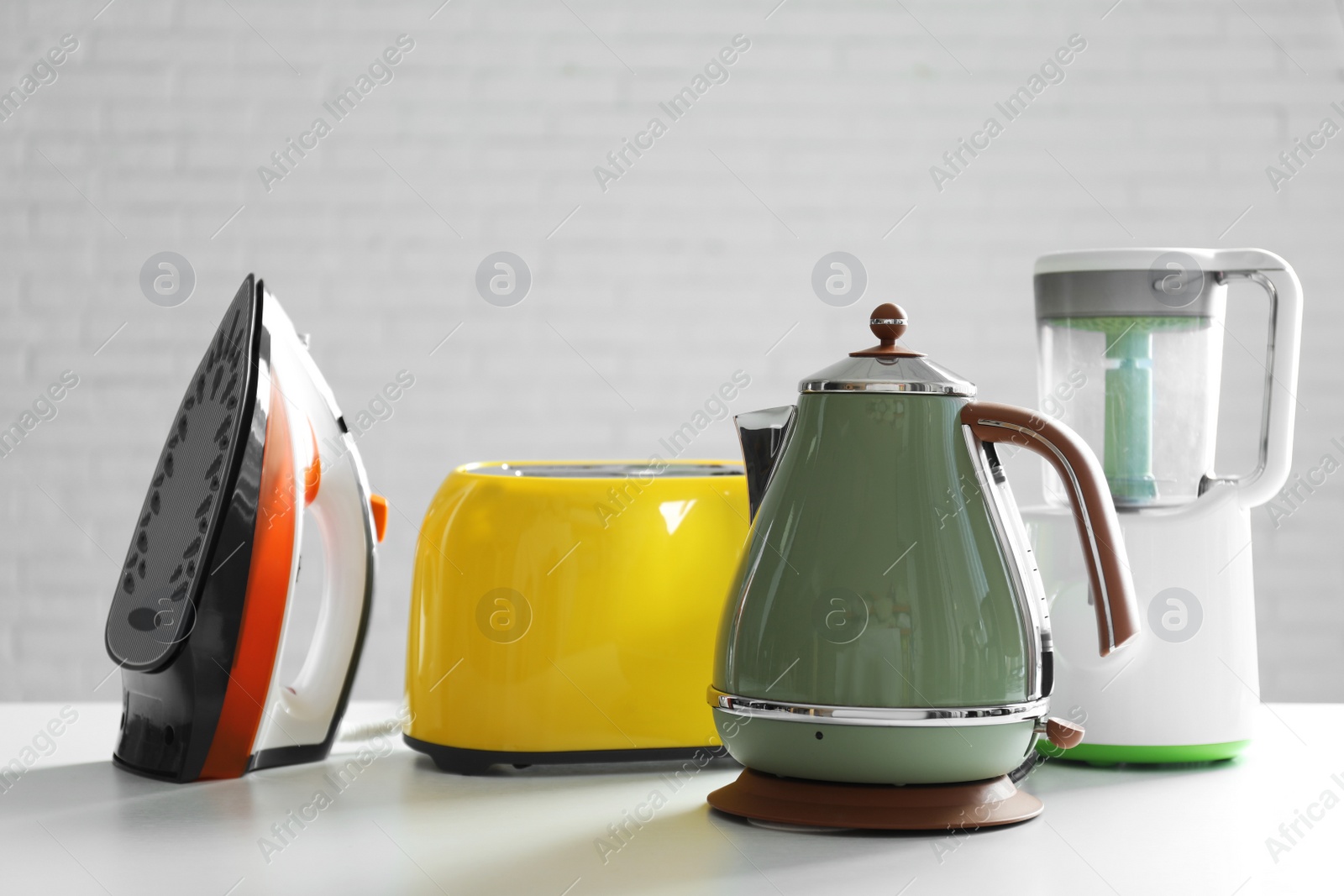 Photo of Set of modern home appliances on white table