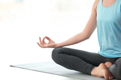 Beautiful woman meditating indoors, space for text. Zen yoga