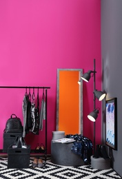 Photo of Stylish dressing room interior with clothes rack and mirror