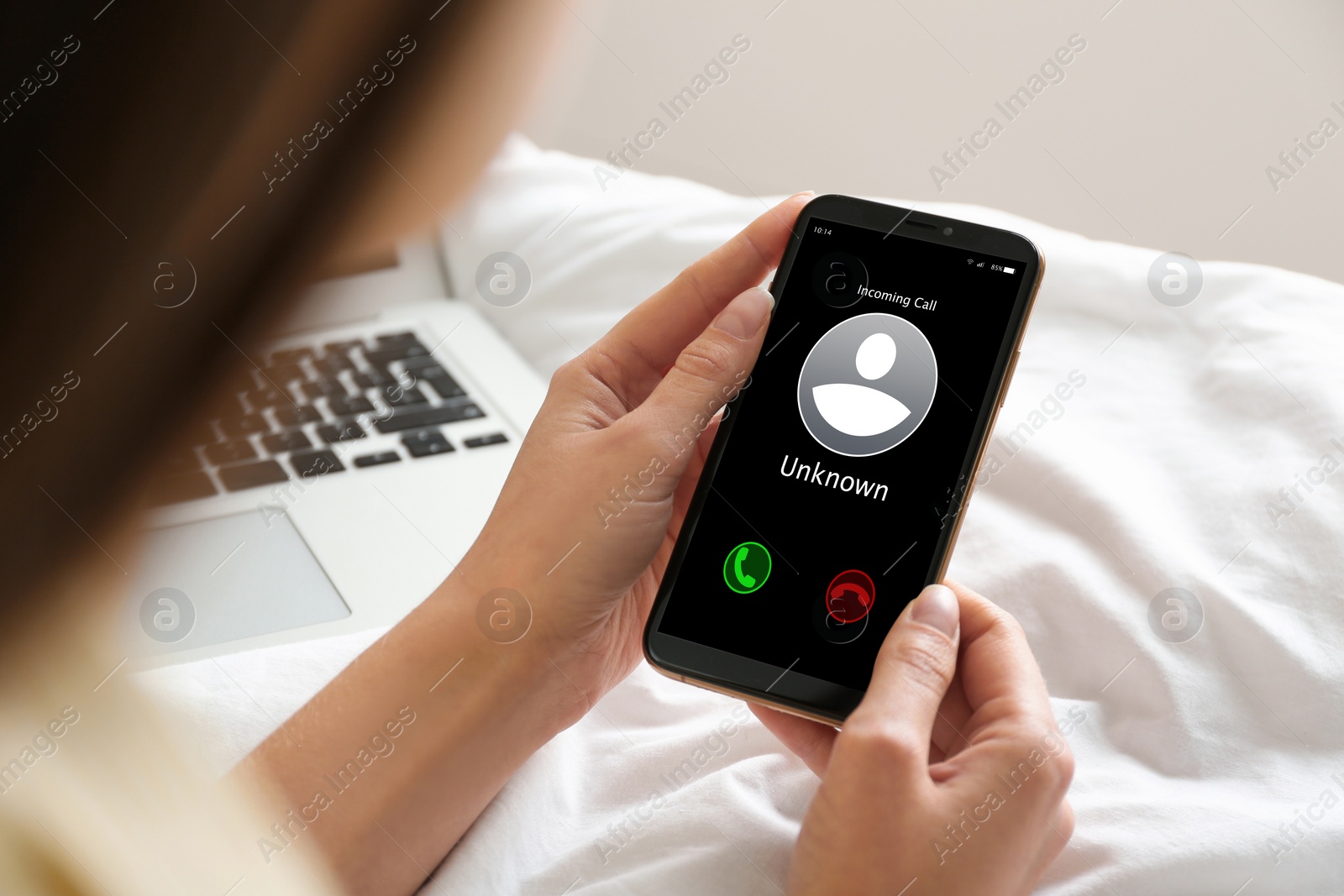 Image of Woman deciding answer incoming call from unknown caller or not at home, closeup. Be careful - fraud
