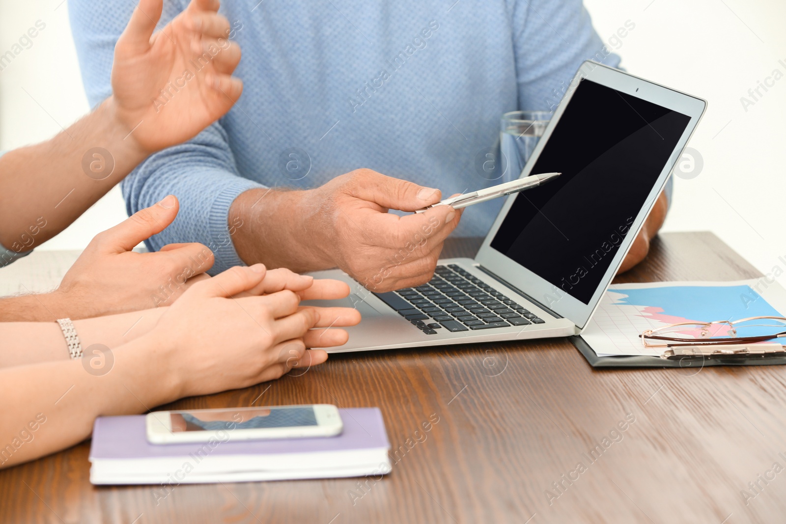 Photo of Mature manager consulting couple in office