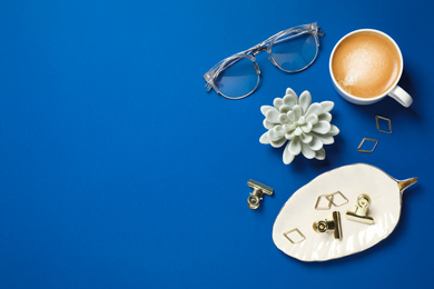 Photo of Flat lay composition with classic black coffee and space for text on blue background. Color of the year 2020