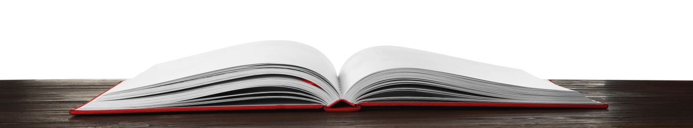 Photo of Open book with red cover on wooden table against white background