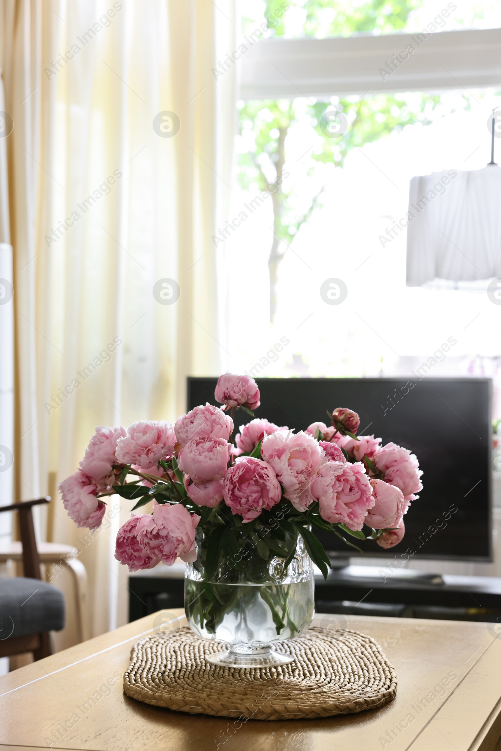 Photo of Beautiful pink peonies in vase on table at home, space for text. Interior design