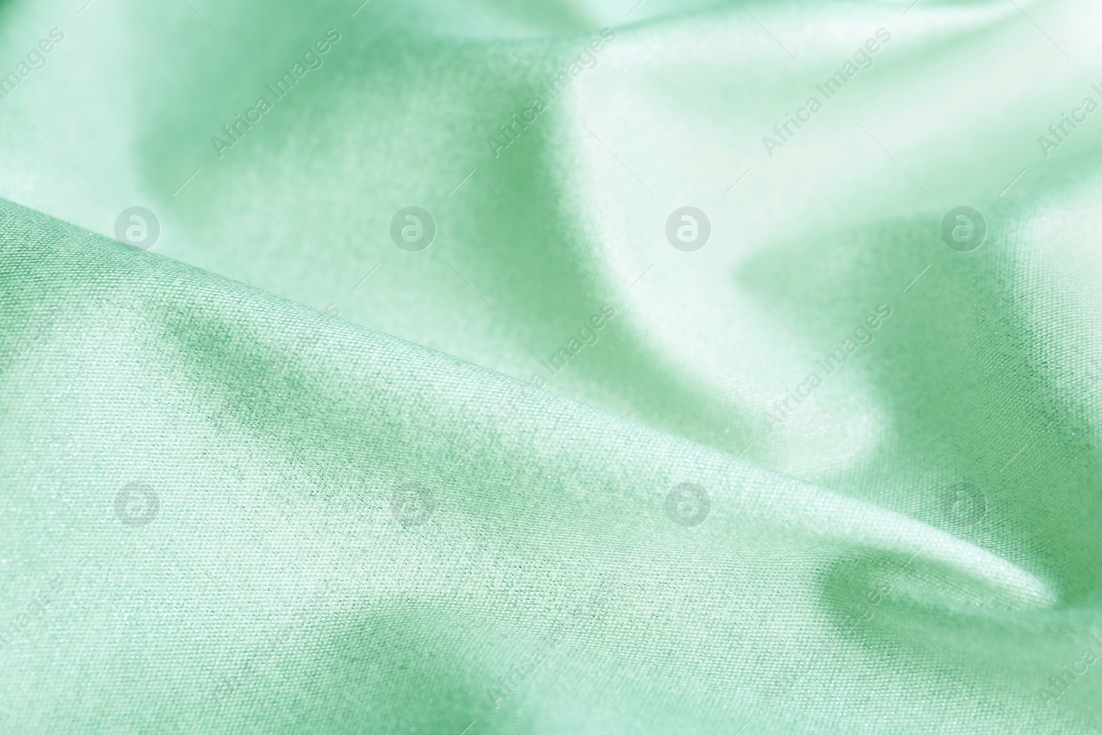 Image of Texture of beautiful silk as background. Image toned in mint color 
