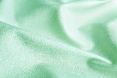 Texture of beautiful silk as background. Image toned in mint color 