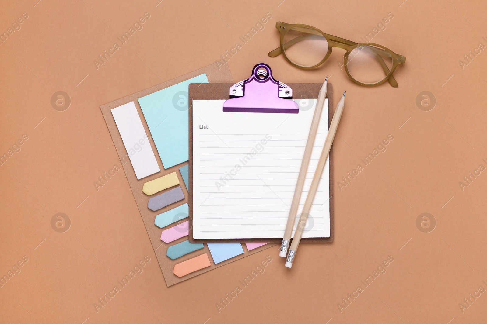 Photo of To do notes, stationery and glasses on brown background, flat lay with space for text. Set for daily planner