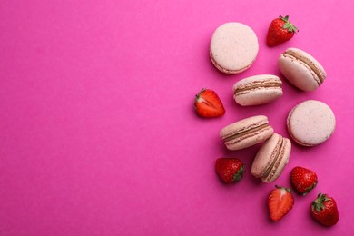 Delicious macarons and fresh strawberries on pink background, flat lay. Space for text