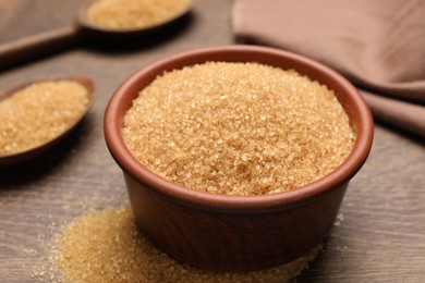 Photo of Brown sugar on wooden table, closeup view