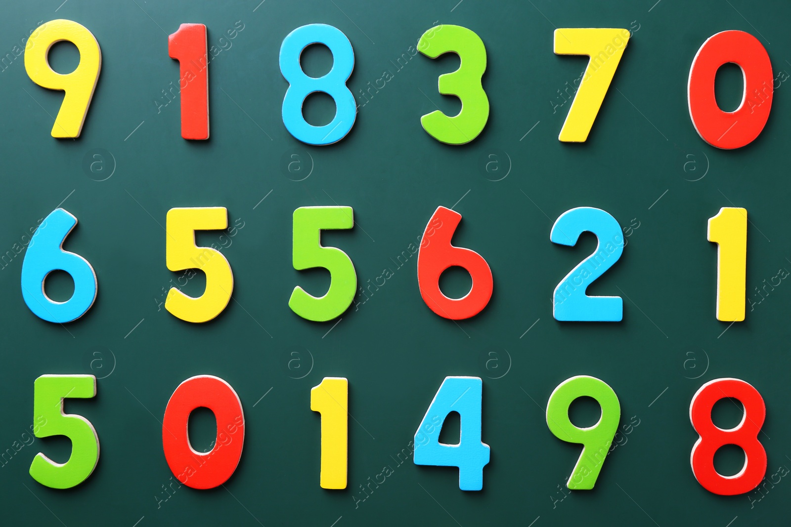 Photo of Colorful numbers on green background, flat lay