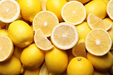 Photo of Many fresh ripe lemons as background, closeup
