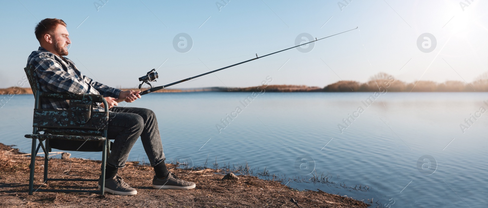 Image of Fisherman with rod fishing at riverside. Banner design