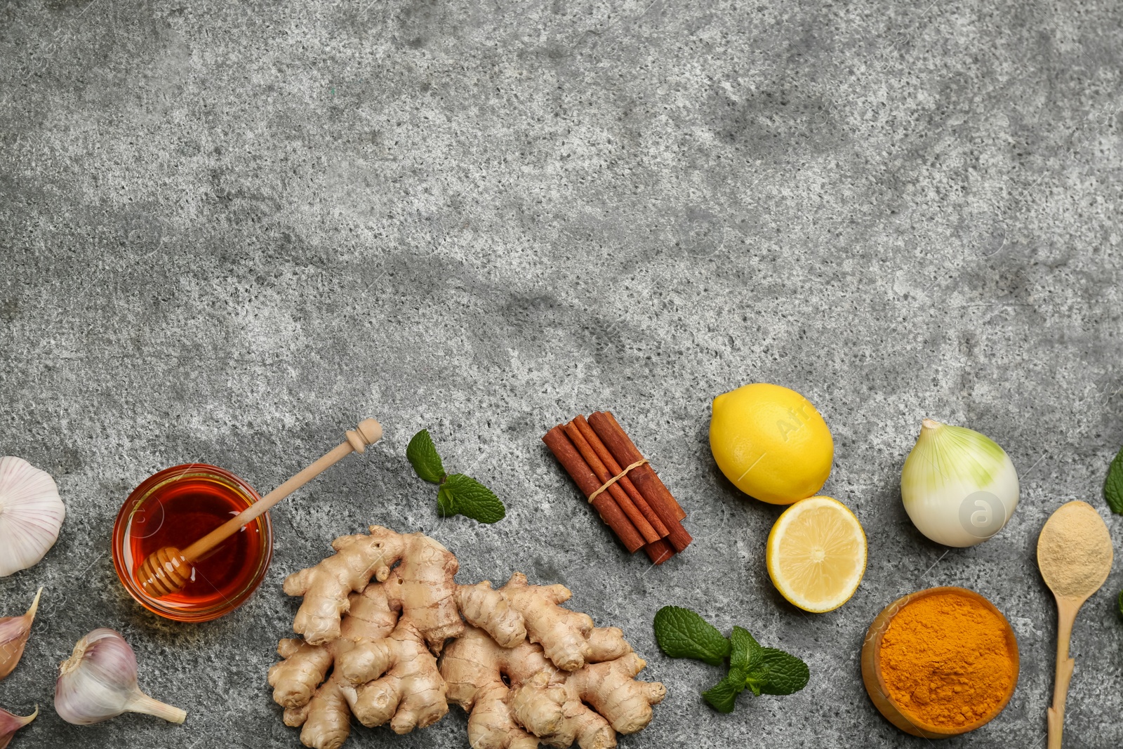 Photo of Flat lay composition with fresh products on grey table, space for text. Natural antibiotics