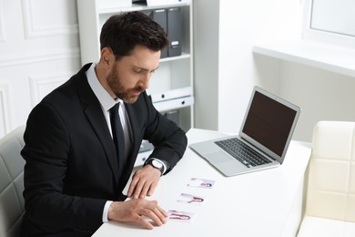 Photo of Human resources manager choosing employee among different applicants in office