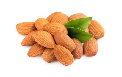 Photo of Pile of almond nuts and green leaves on white background. Healthy snack