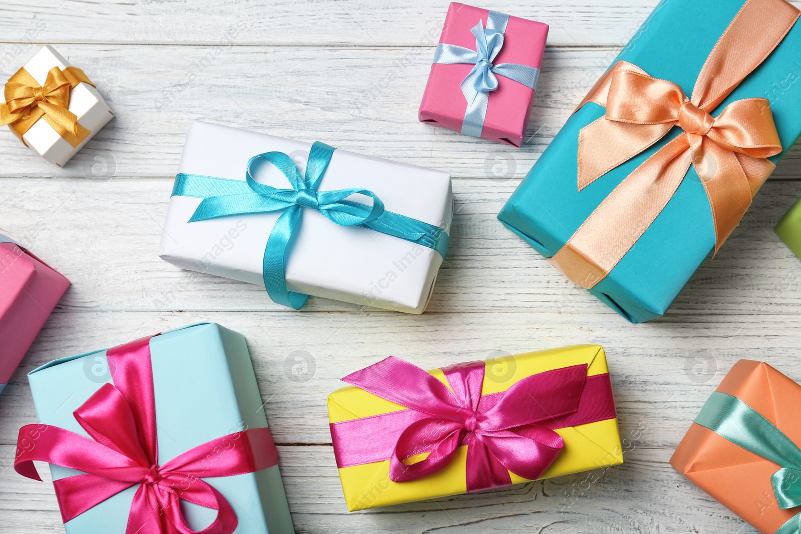 Photo of Flat lay composition with beautiful gift boxes on wooden background