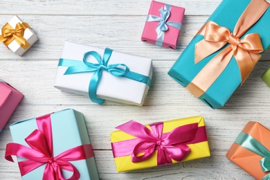 Photo of Flat lay composition with beautiful gift boxes on wooden background