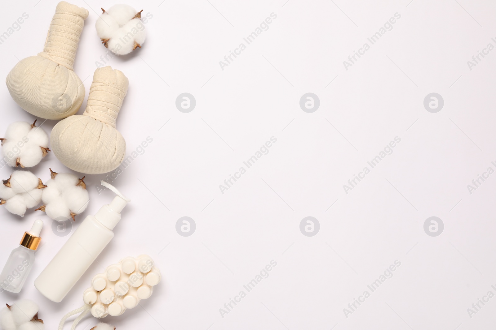 Photo of Bath accessories. Different personal care products and cotton flowers on white background, flat lay with space for text