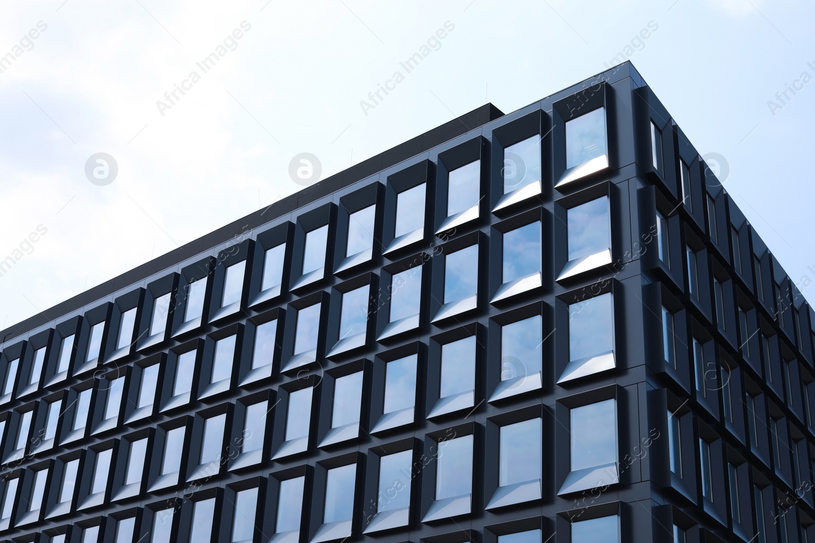 Photo of Building with tinted windows, outdoors. Modern architectural design