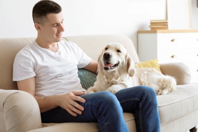 Photo of Portrait of owner with his friendly dog at home