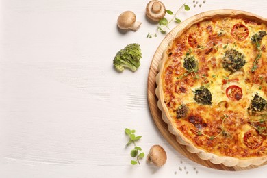 Photo of Delicious homemade vegetable quiche, mushrooms and broccoli on wooden table, flat lay. Space for text