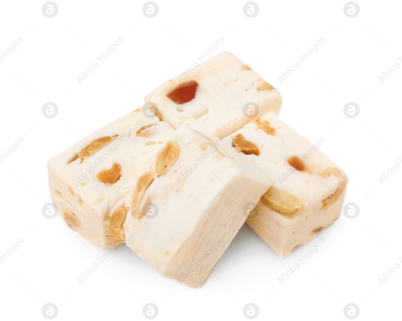 Photo of Many pieces of delicious nougat on white background