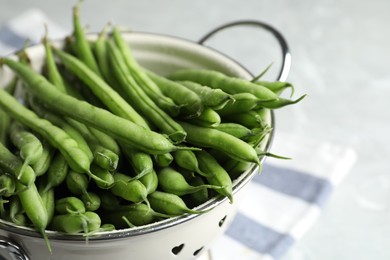 Photo of Fresh green beans in colander, closeup view