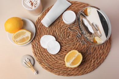 Lemon face wash. Fresh citrus fruits, personal care products and mirror on beige background, flat lay