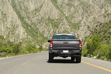 Black car on road near beautiful mountains outdoors