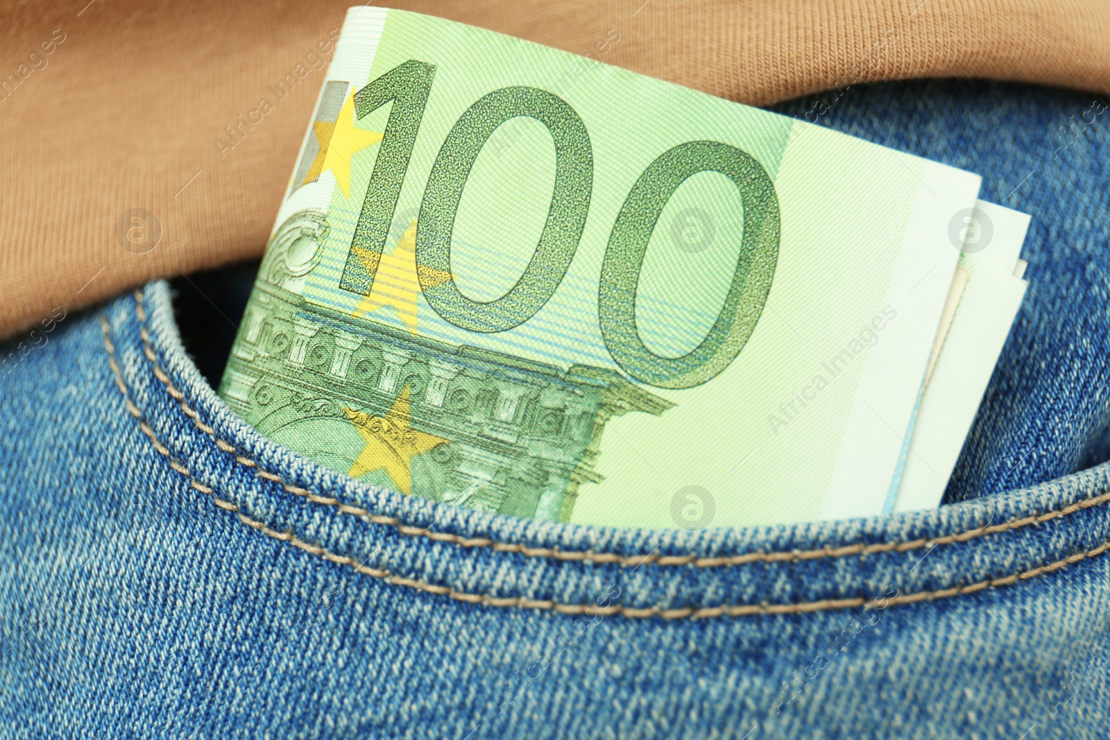 Photo of Person with Euro banknotes in pocket of jeans, closeup