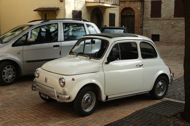 Photo of GRONINGEN, NETHERLANDS - APRIL 23, 2022: White Fiat 500F 1968 parked on city street