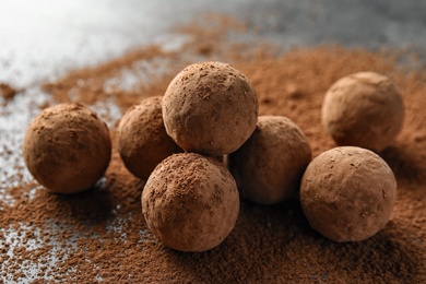 Delicious raw chocolate truffles on grey background