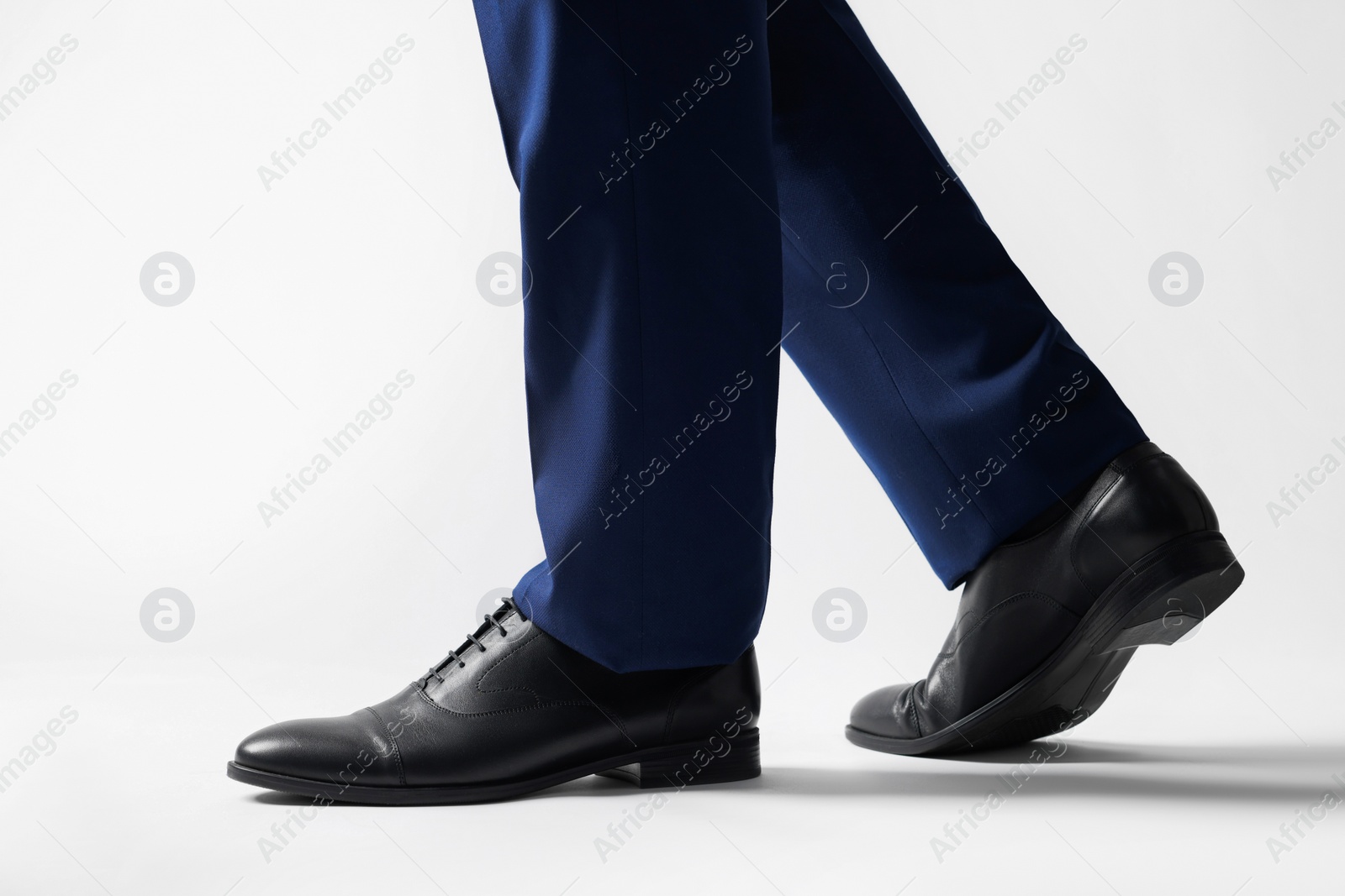 Photo of Businessman in leather shoes on white background, closeup