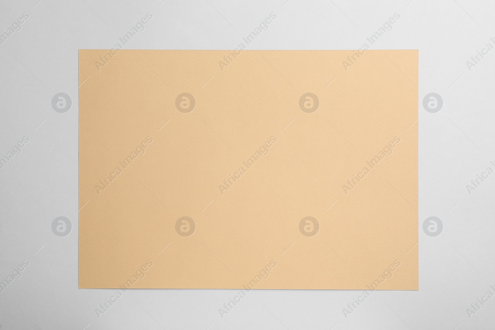 Photo of Sheet of brown paper on white background, top view