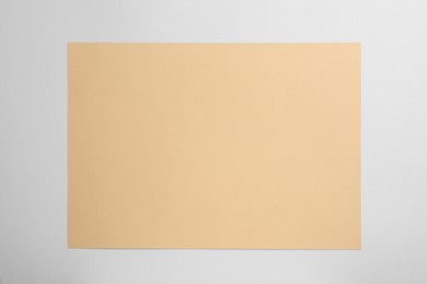 Photo of Sheet of brown paper on white background, top view