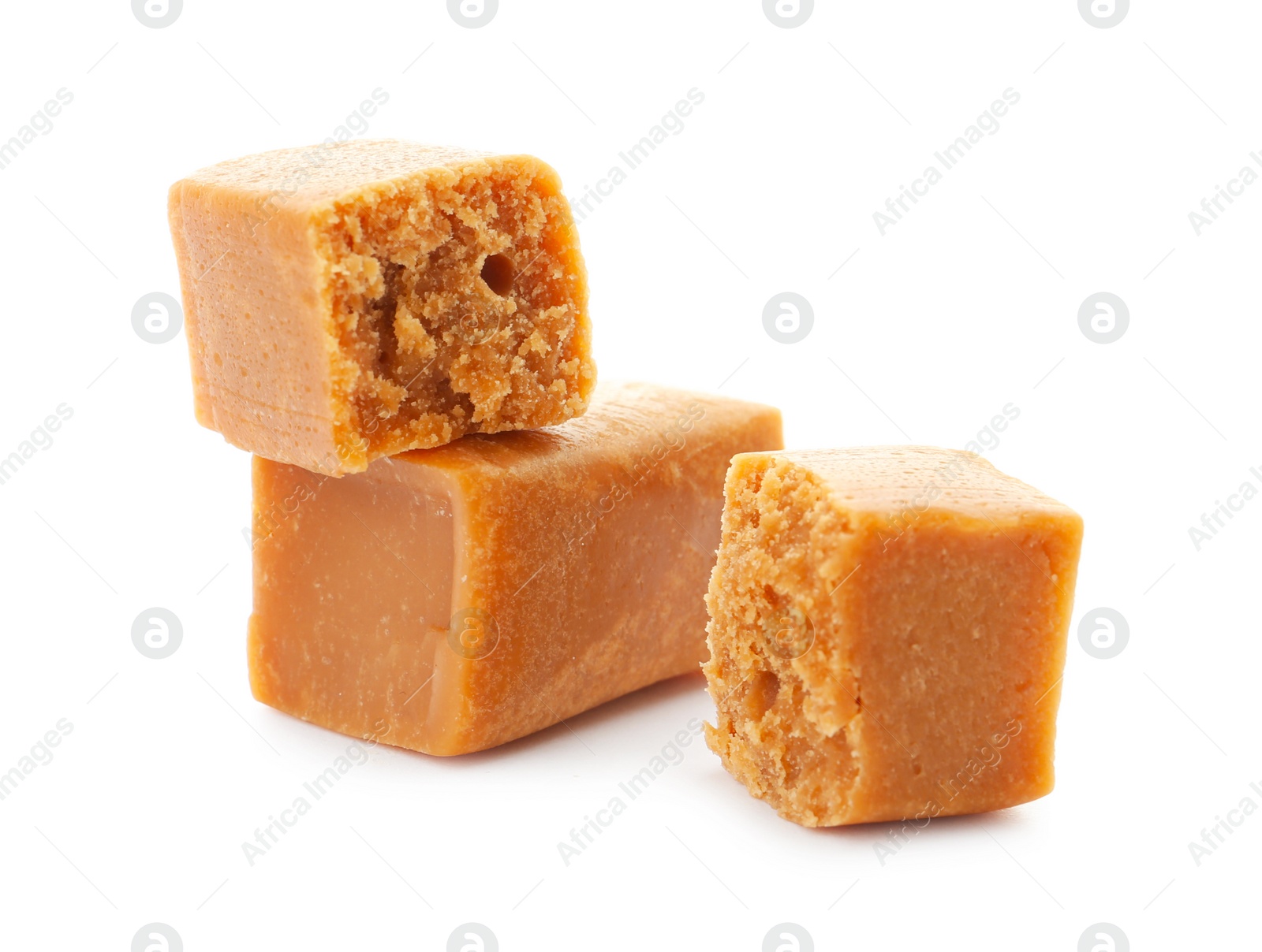 Photo of Delicious caramel candies on white background