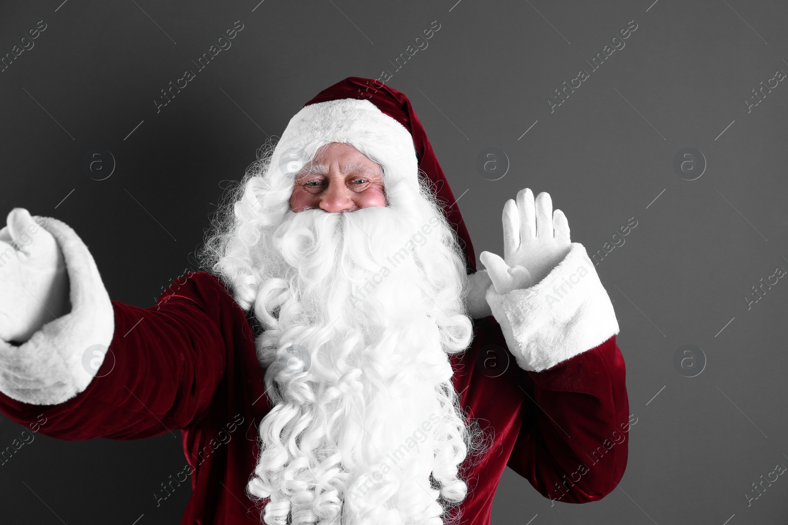 Photo of Authentic Santa Claus taking selfie on grey background