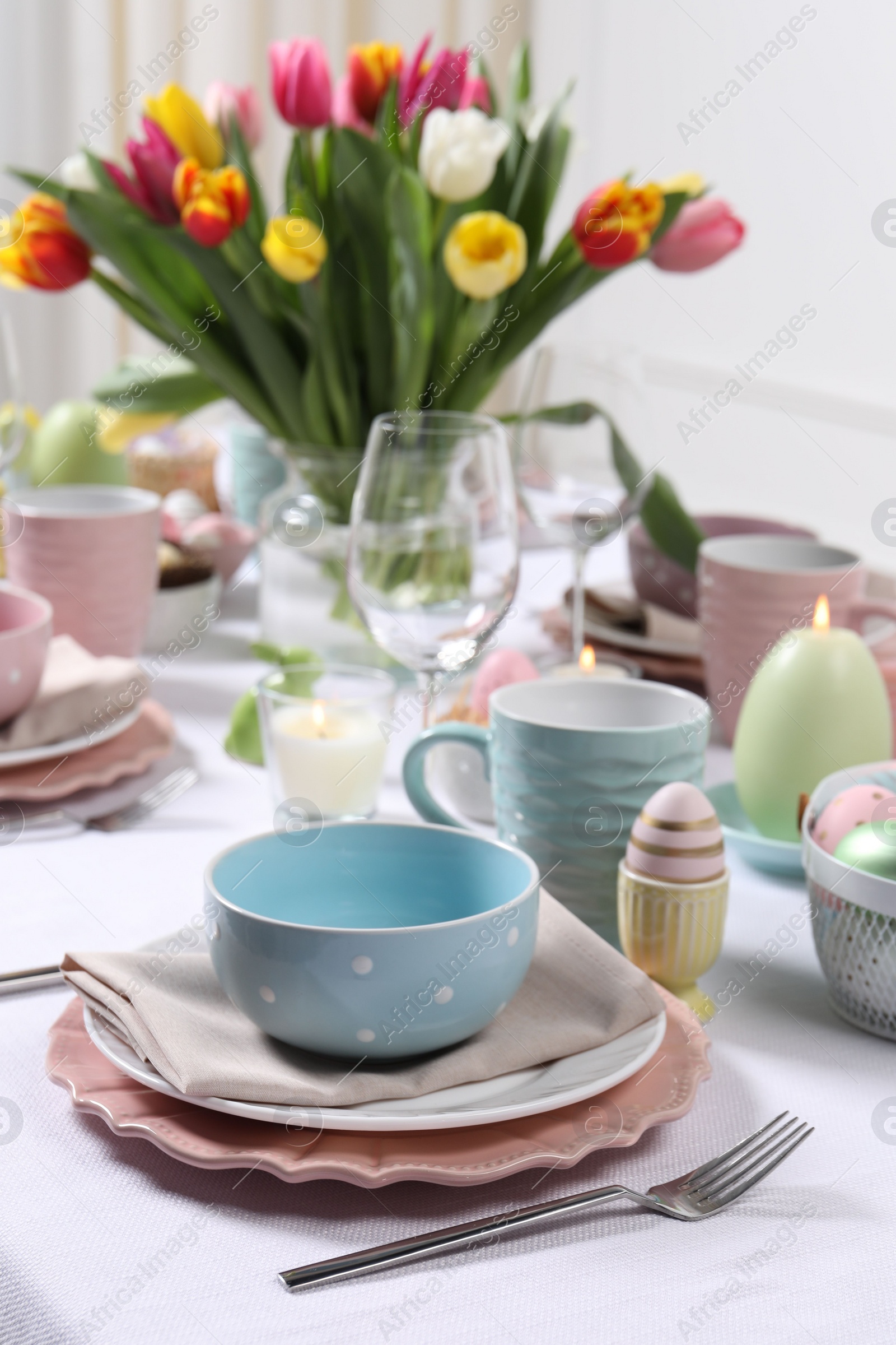 Photo of Festive table setting with beautiful flowers. Easter celebration